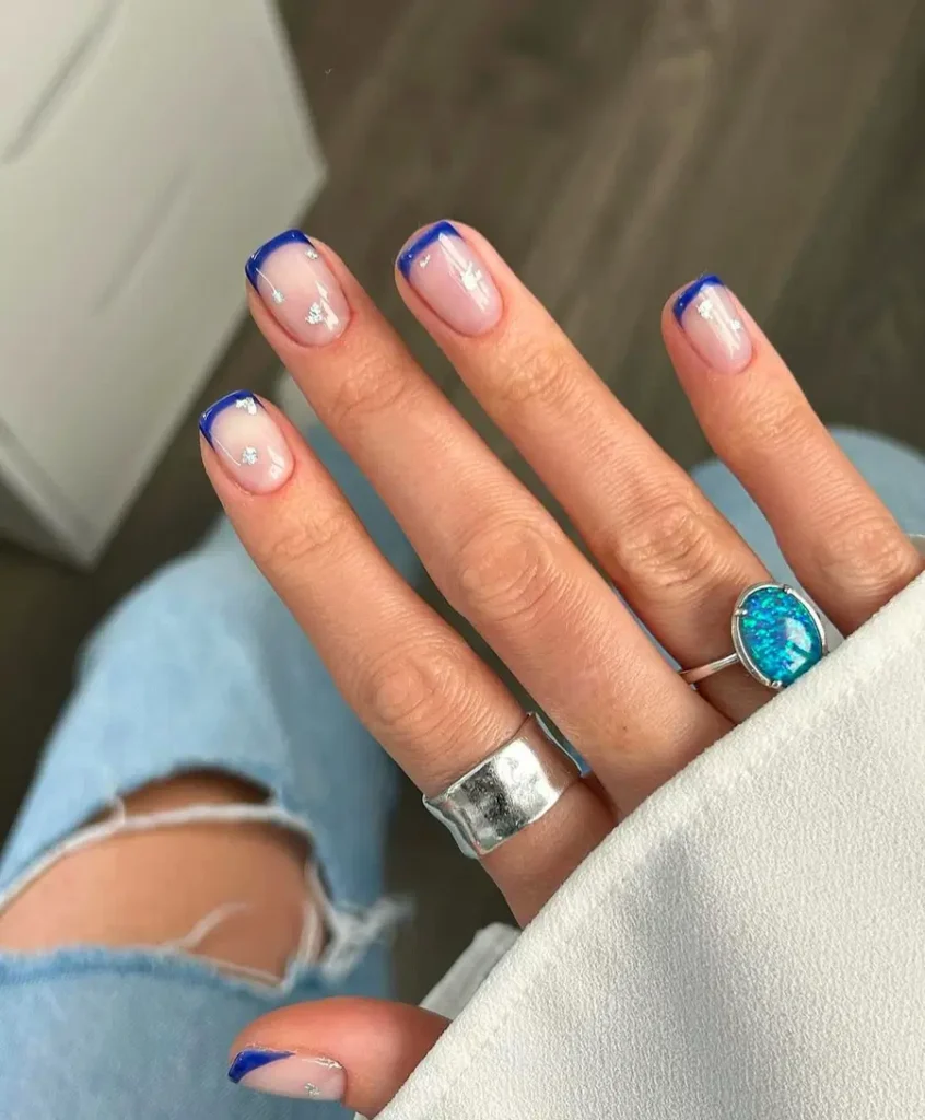 Deep Blue French Tip Nails With Subtle Crystal Accents