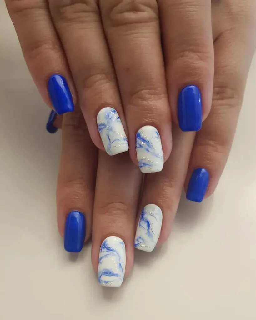 Classic Blue Nails With Soft White Marble Accents