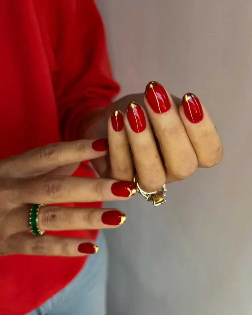 Classic Red Nails With Subtle Gold-Tipped Elegance