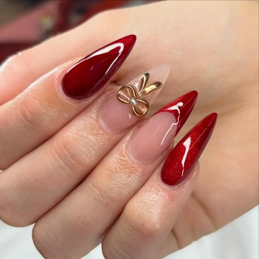 Stiletto Nails With a Sculpted Gold Bow Accent