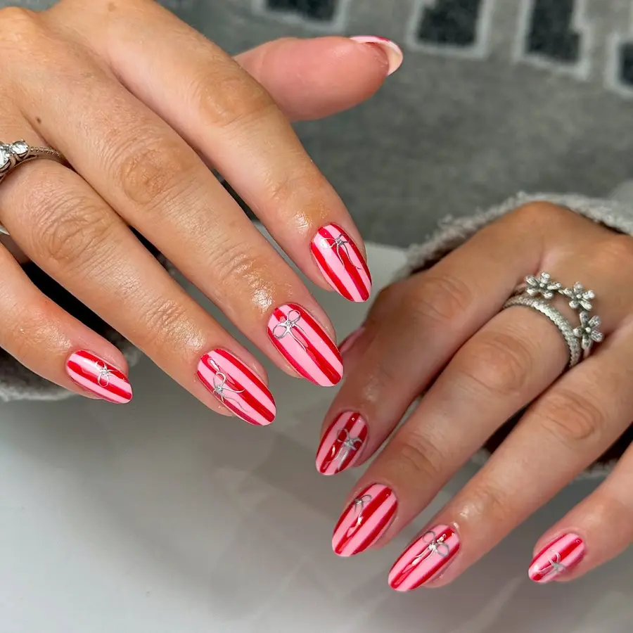 Short Red Nails With Vertical Stripes and Minimal Bow Accents