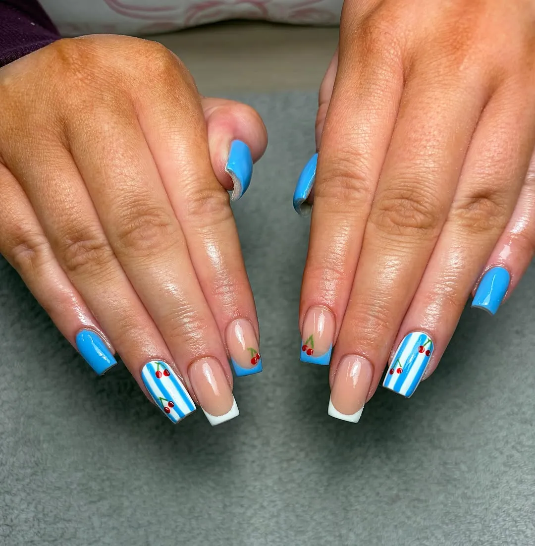 Blue French tips with striped cherry accent nails