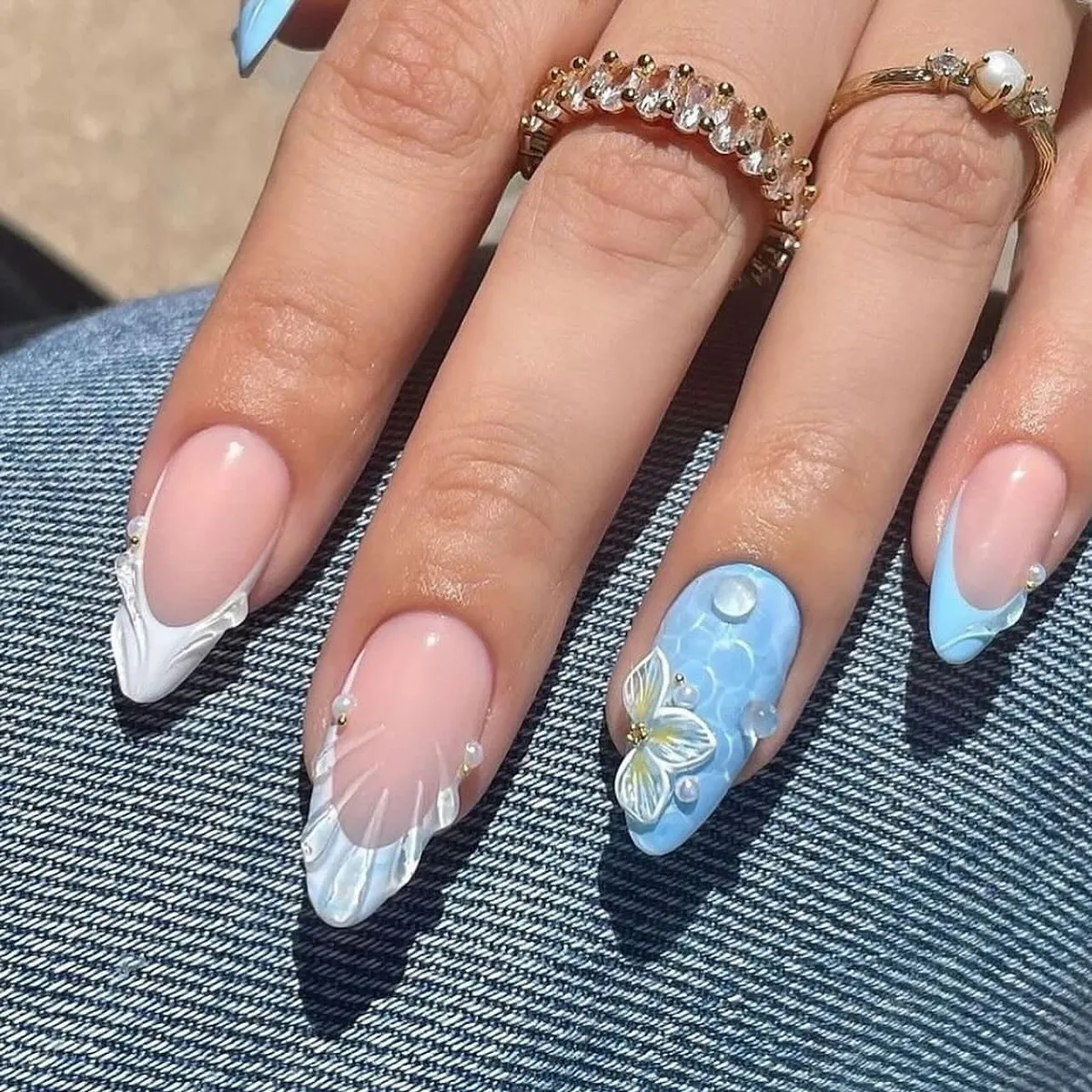 Nude base with sculpted white tips and blue butterfly accent