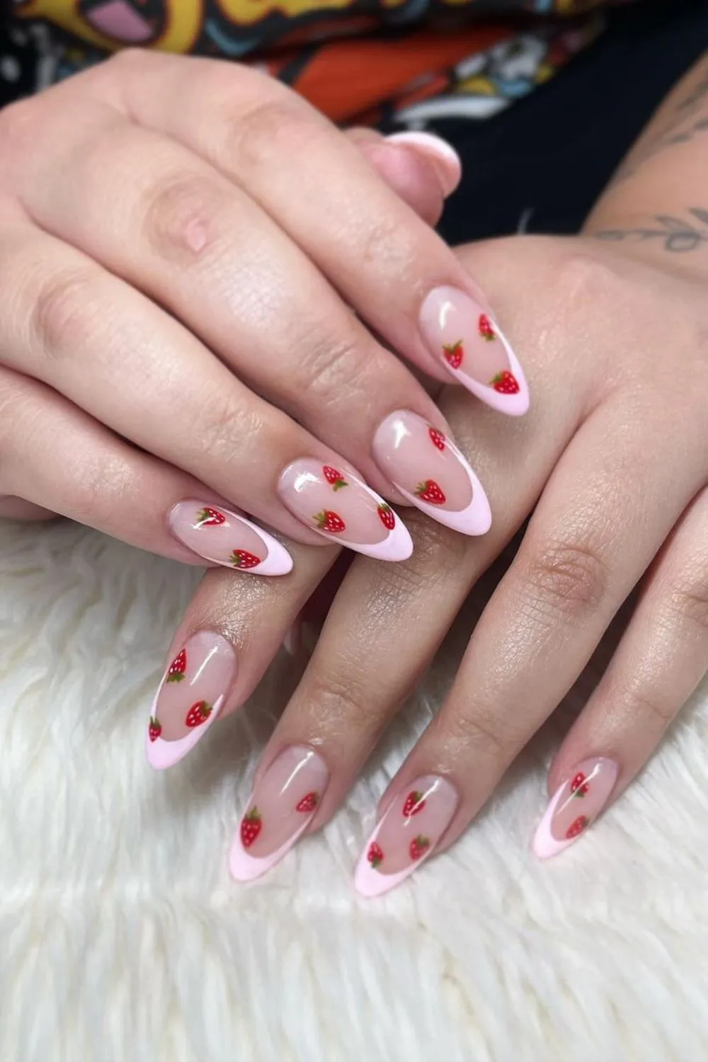 Pale pink French tips with strawberry motifs