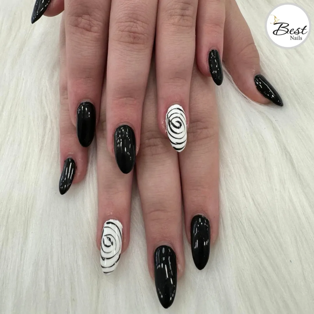 Solid black almond nails with white spiral accent nails