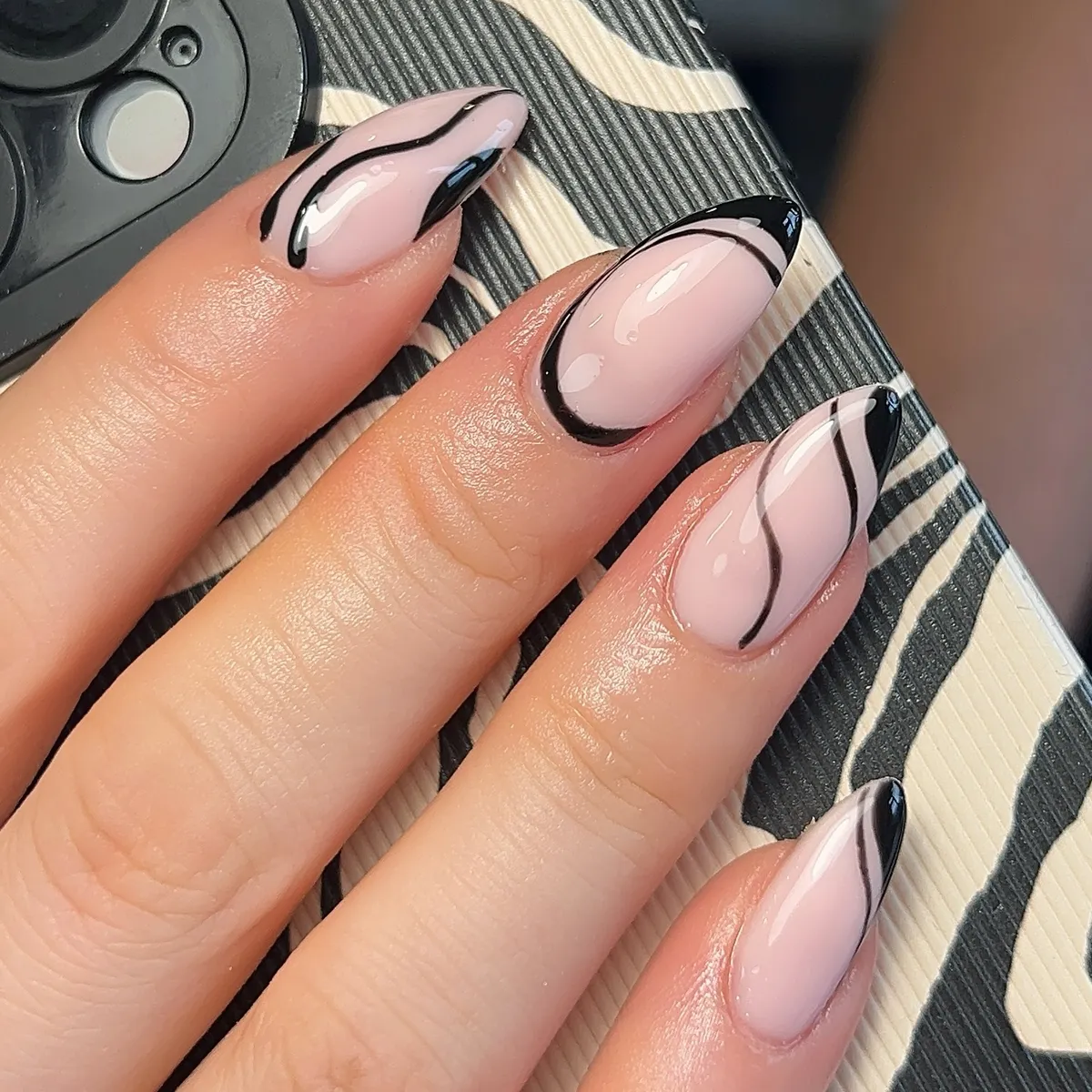 Abstract black swoop lines over a pale pink base