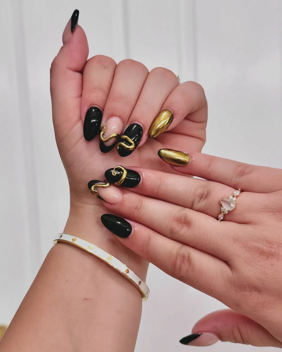 Black and metallic gold with raised curved gold accents