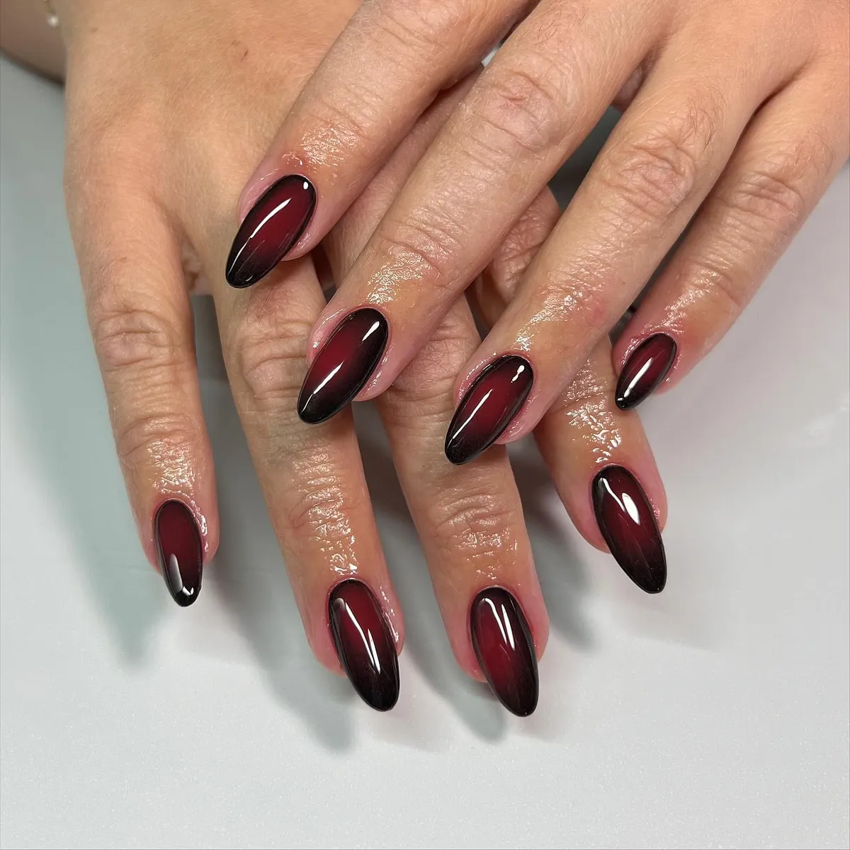 Glossy red-to-black gradient nails