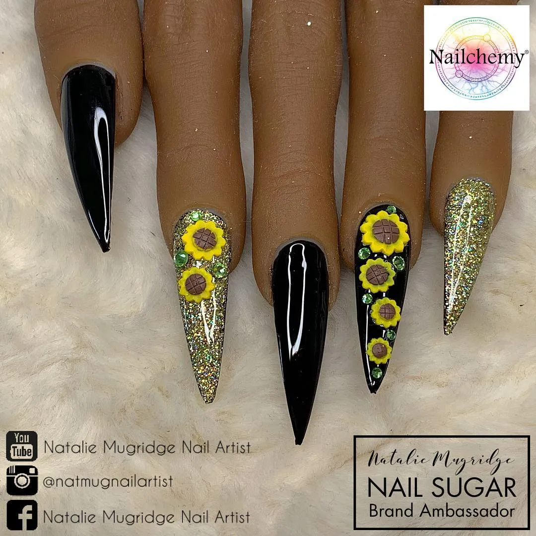 Stiletto mix: glossy black, gold glitter, and raised sunflower embellishments