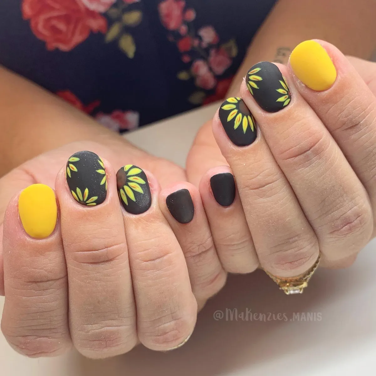 Matte black-and-yellow nails with petal-ring accents