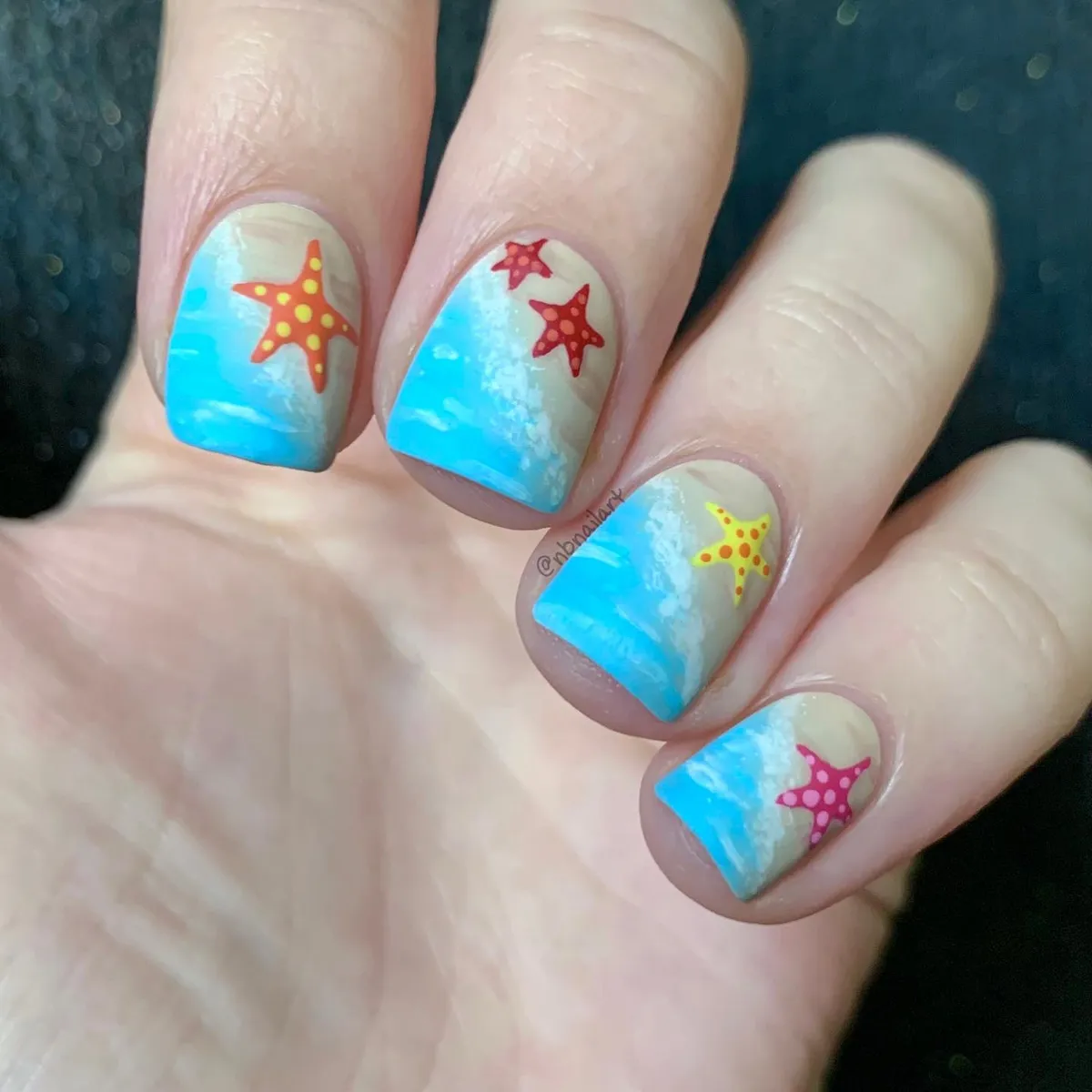 Blue-and-sand gradient with colorful starfish