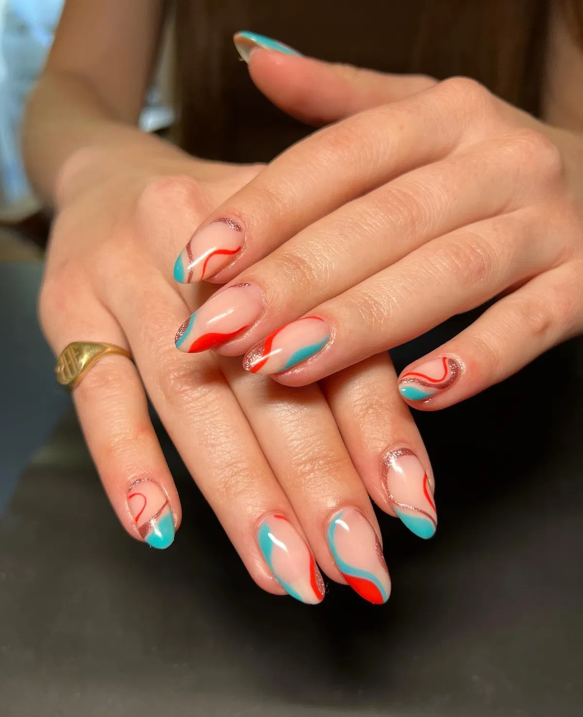 Curved teal and red-orange shapes with glitter lines