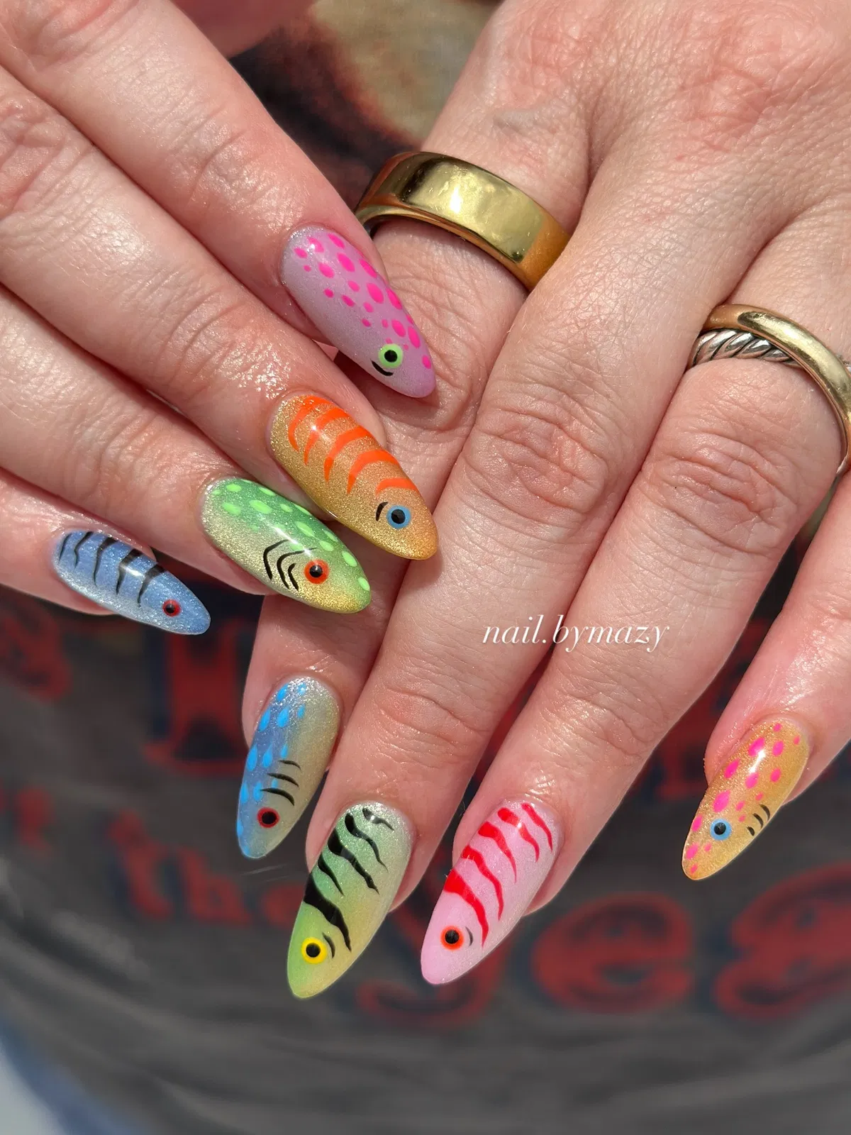 Colorful fish-inspired nails with stripes and spots