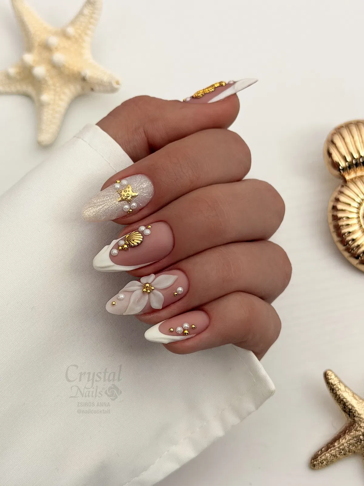 White French tips with gold and pearl embellishments