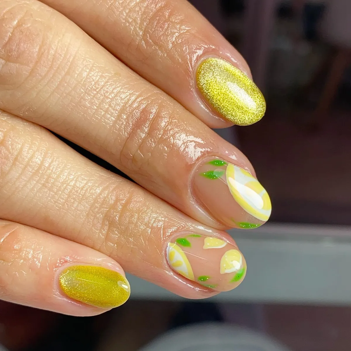 Shimmery gold-yellow paired with nude lemon-slice art