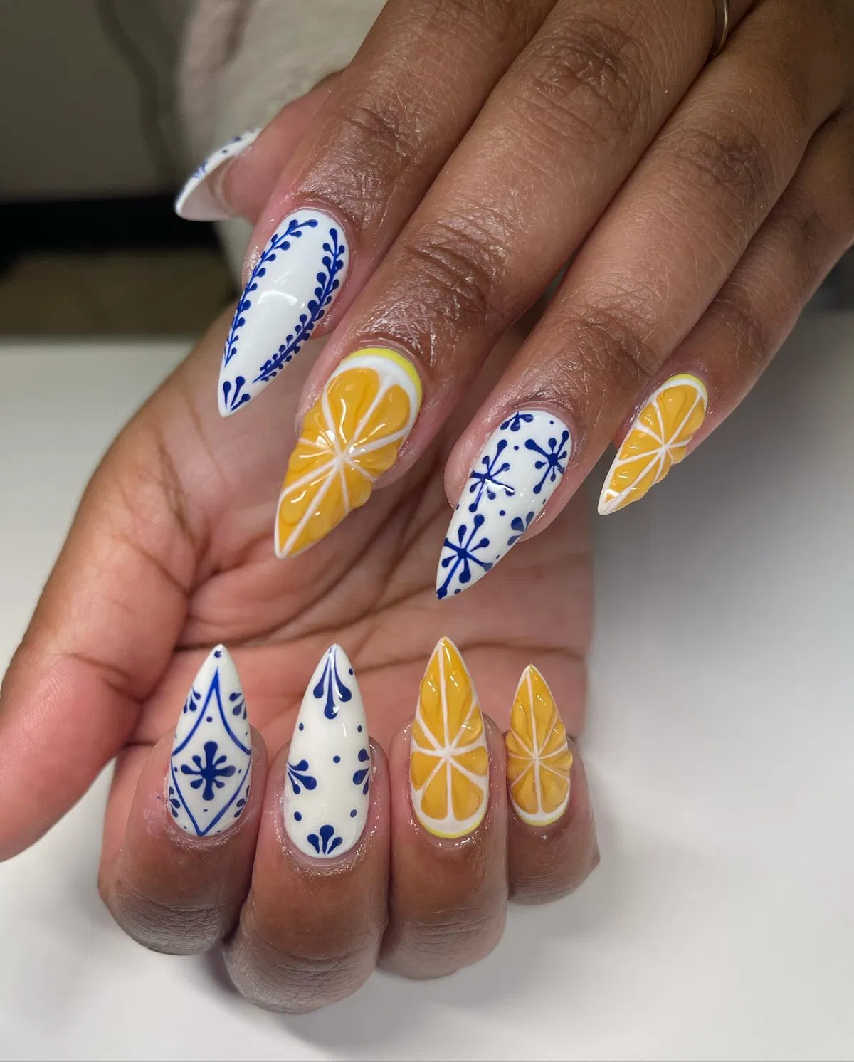 Stiletto set mixing blue ornamental patterns and citrus slices