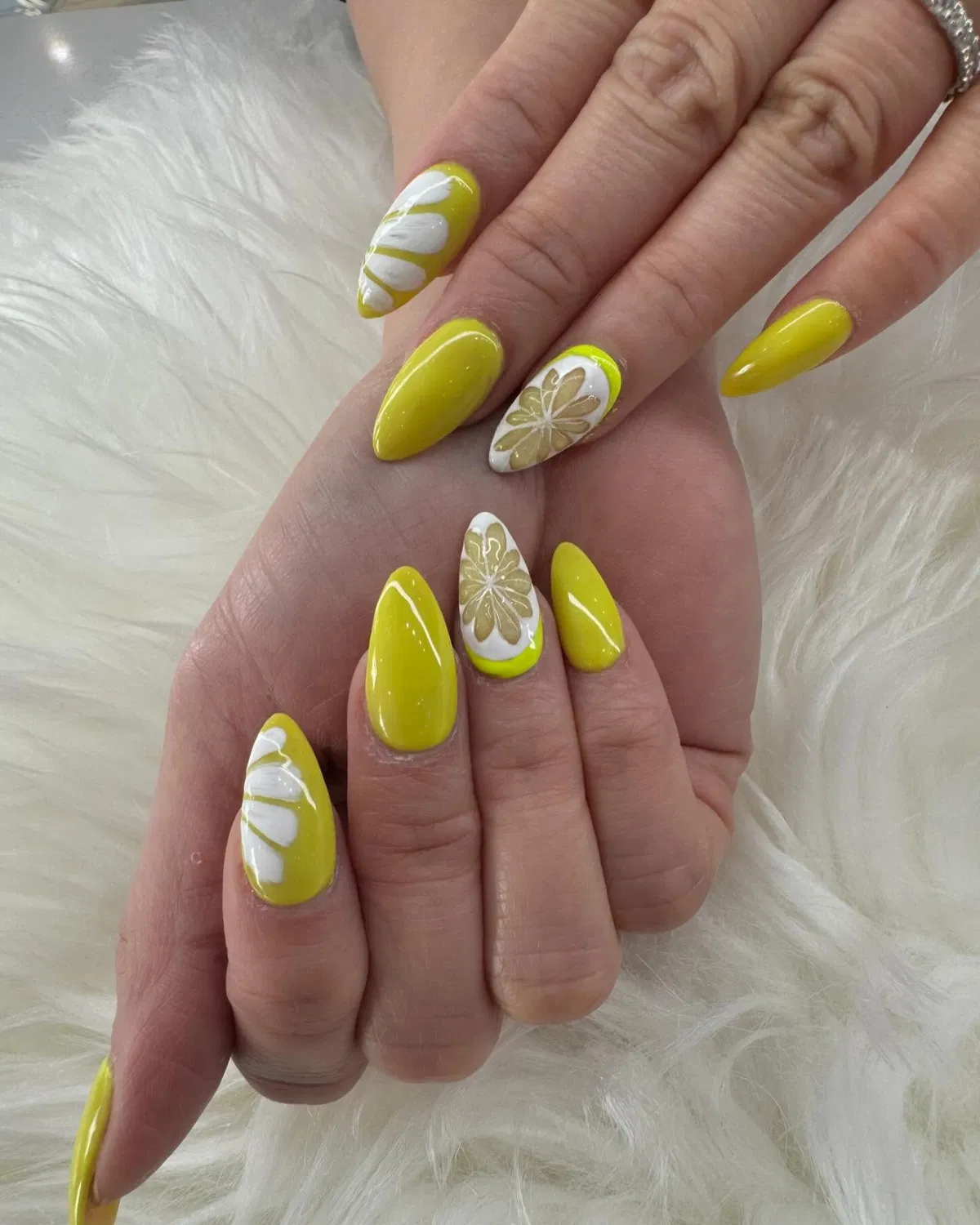 Chartreuse almond nails with citrus-segment accents