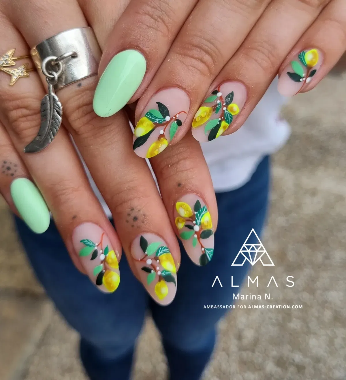 Mint accent with layered yellow-and-green fruit/leaf nail art