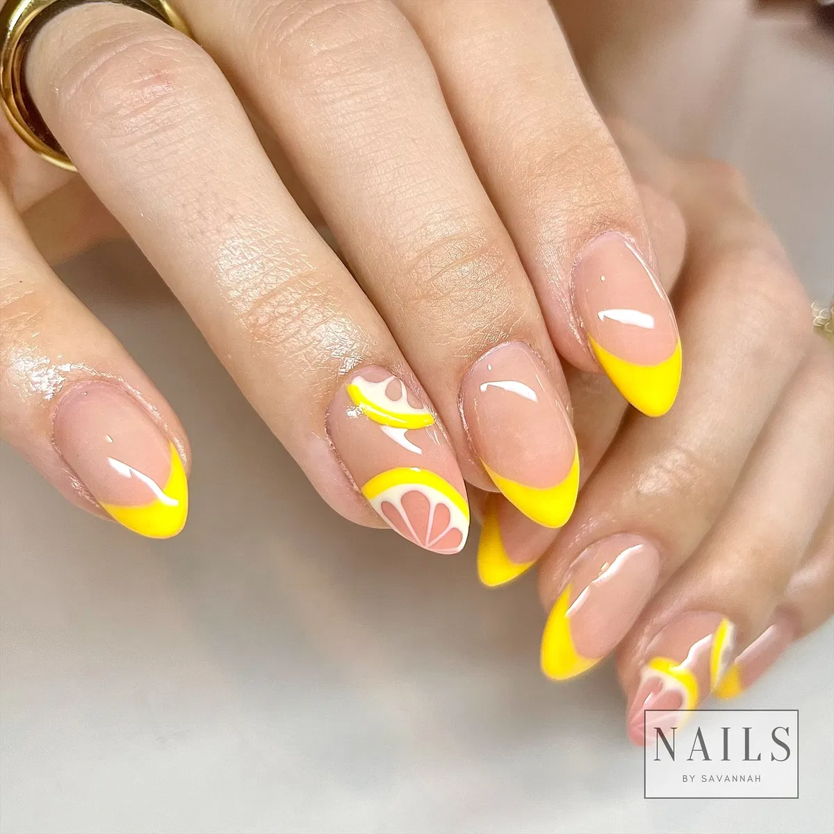 Bright yellow French tips with citrus-slice accents