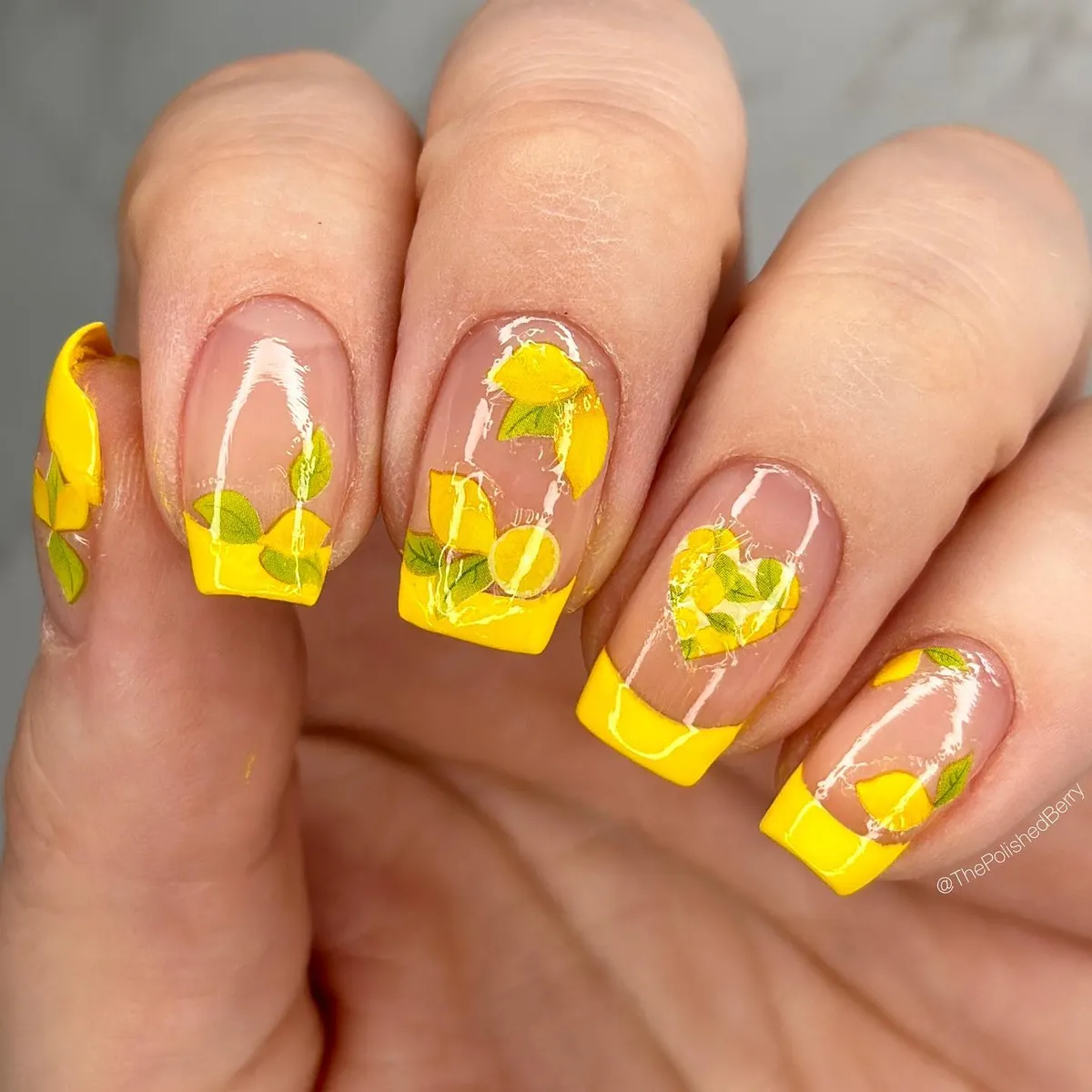 Bold yellow square French tips with fruit-and-leaf overlays