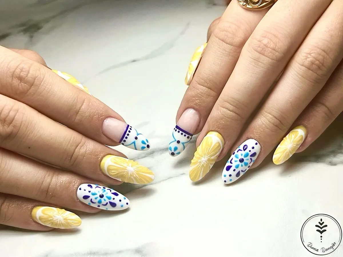 Long almond nails with lemon slices and blue/purple dot florals