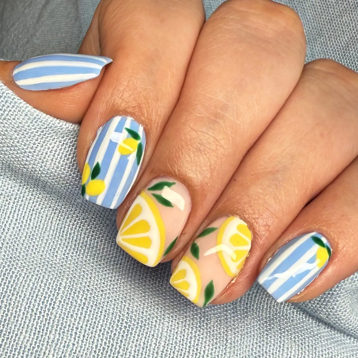 Blue stripes with lemon accents on short square nails
