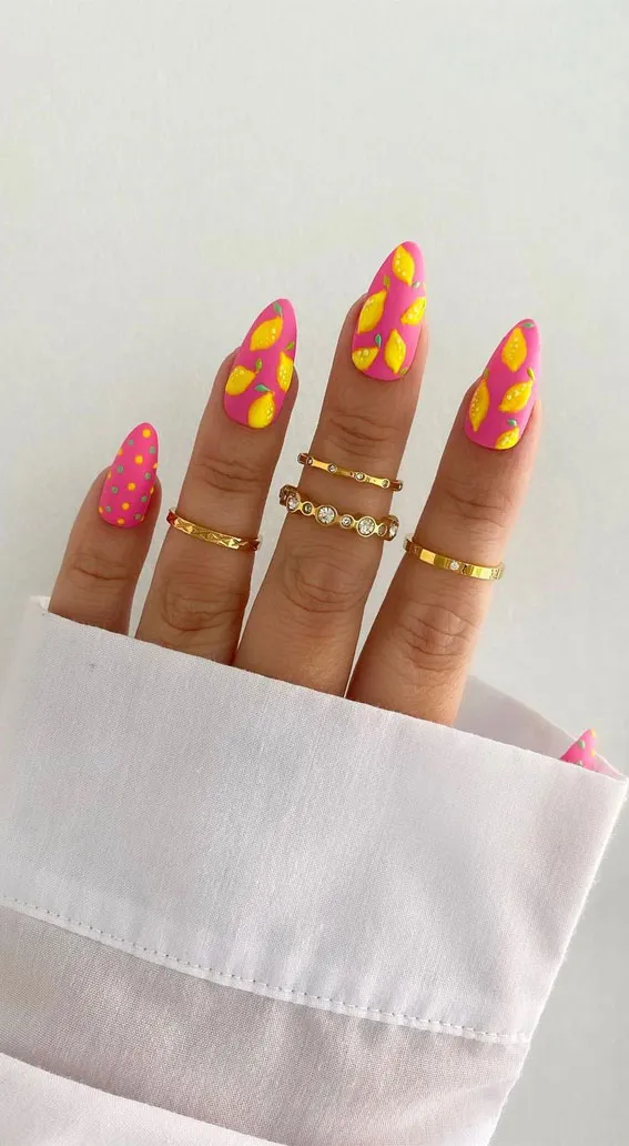 Hot pink nails with repeating yellow lemon shapes