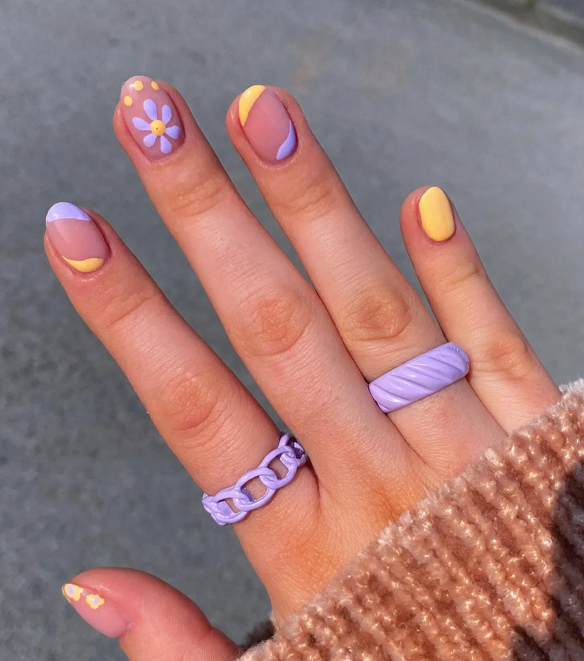 Lavender-and-yellow curves with a flower accent