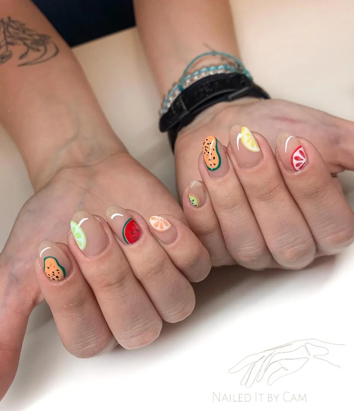 Minimal nude nails with tiny fruit slice accents