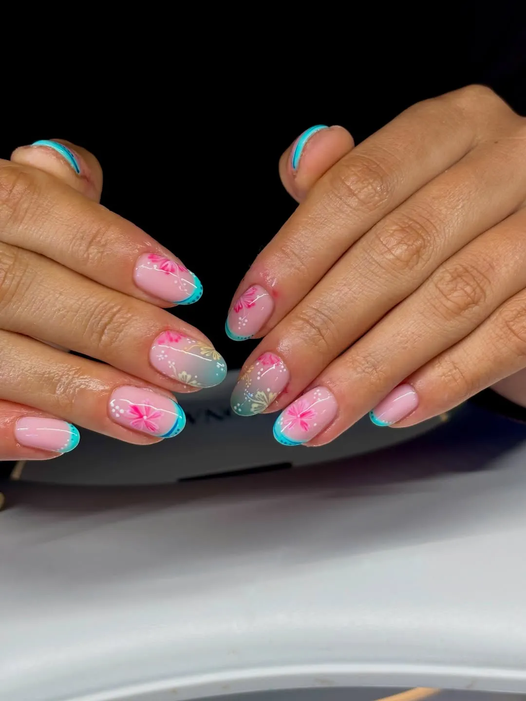 Turquoise French tips with delicate floral overlays