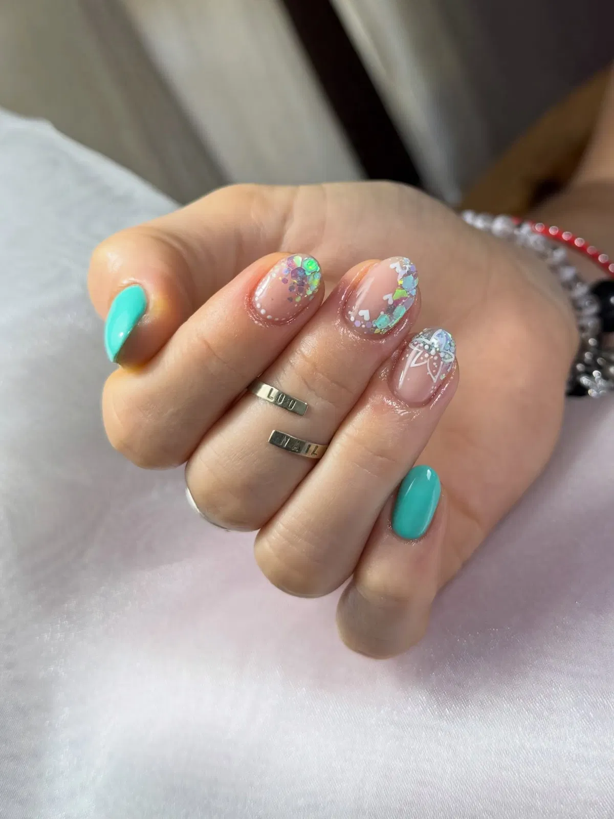 Teal solids with iridescent confetti and white line-art details