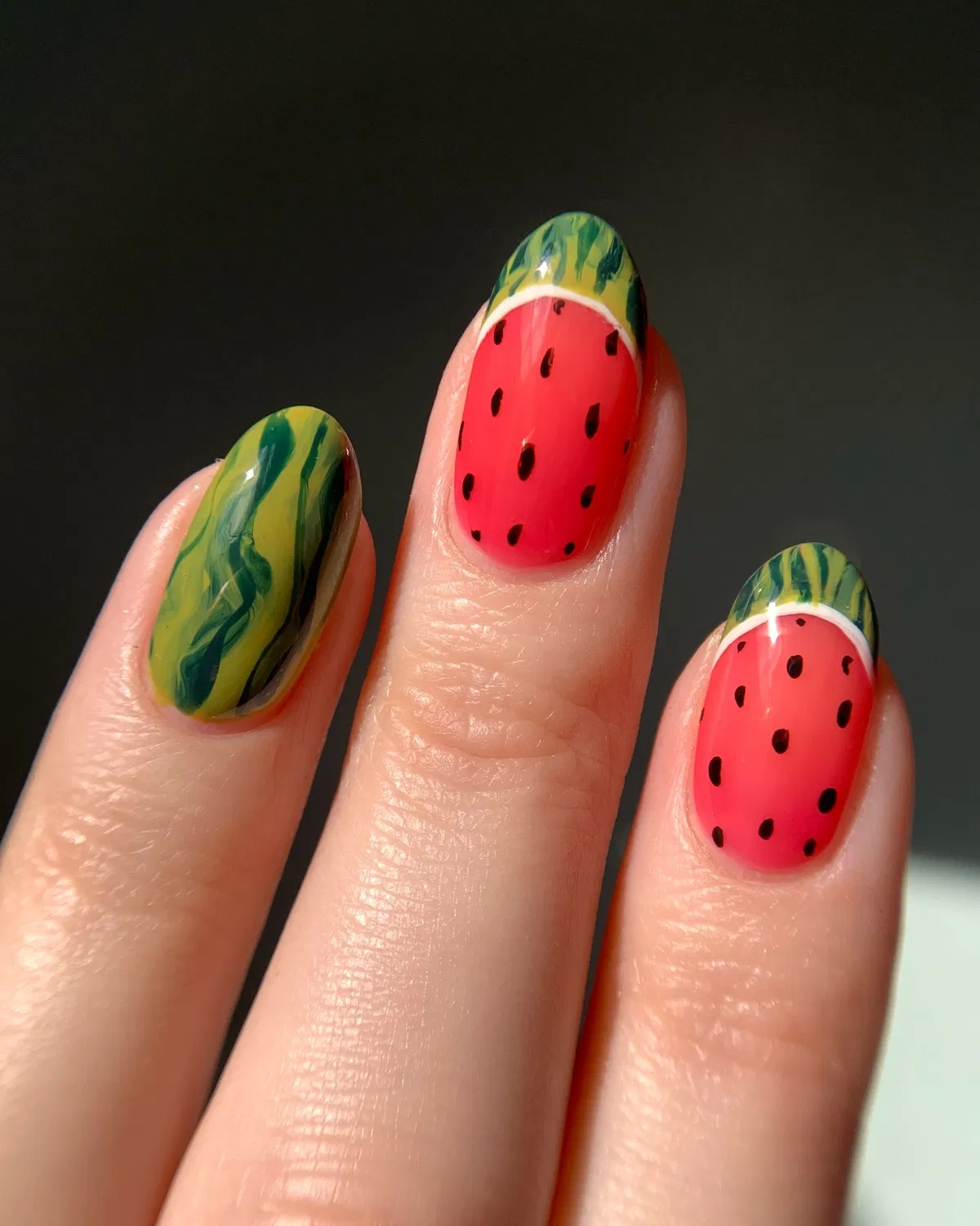 Red-and-green fruit-like motif with black seed dots