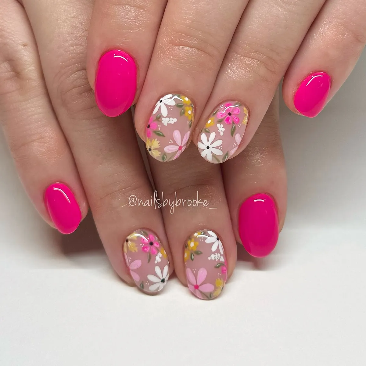 Hot pink paired with nude floral accent nails