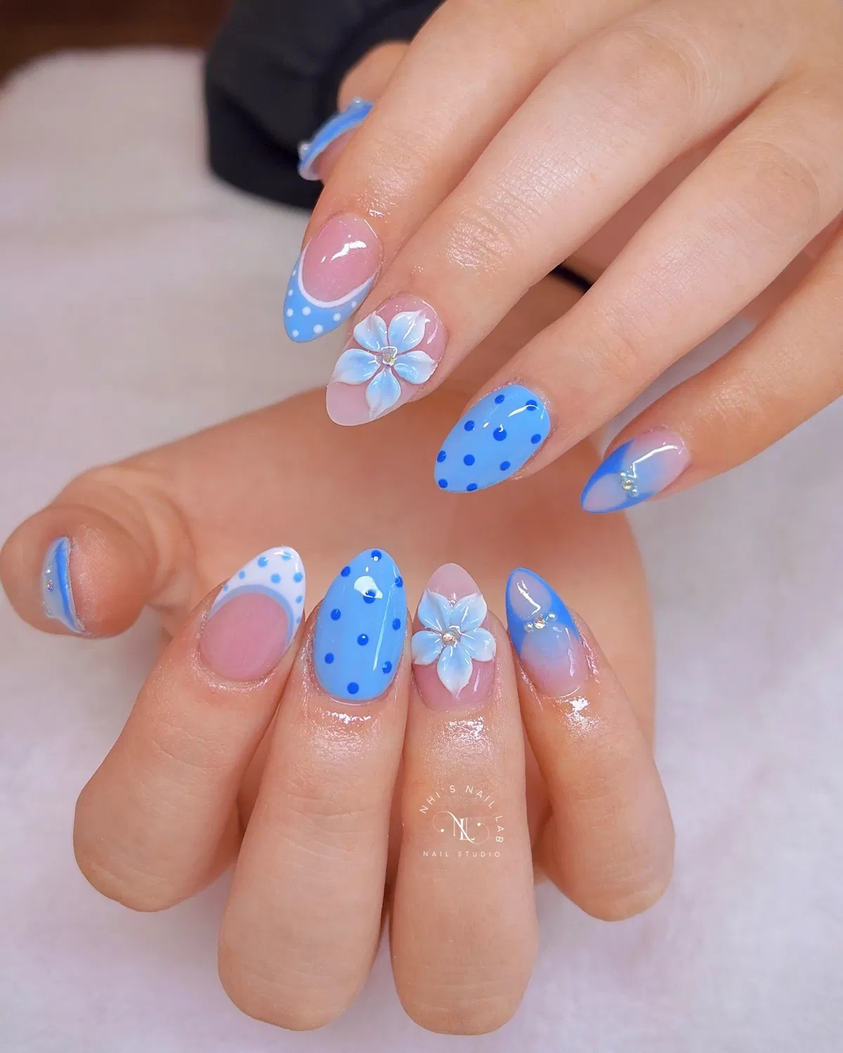 Blue polka dots and curved tips with 3D floral accents
