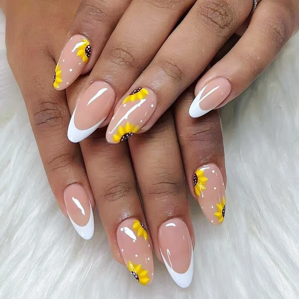 White French tips with scattered sunflower motifs