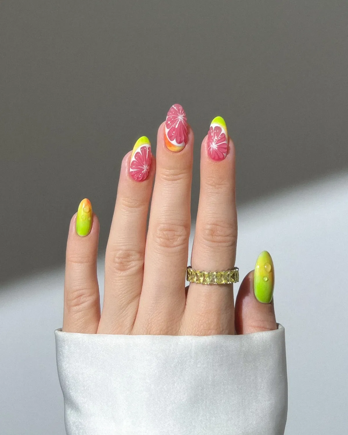 Citrus slice art with neon yellow-green accents and droplets