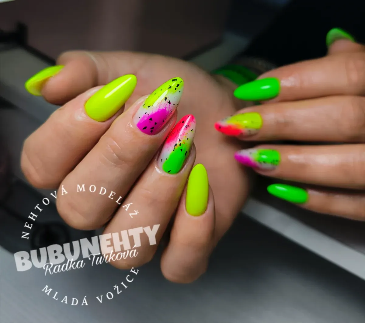 Neon gradient nails with black speckle accents