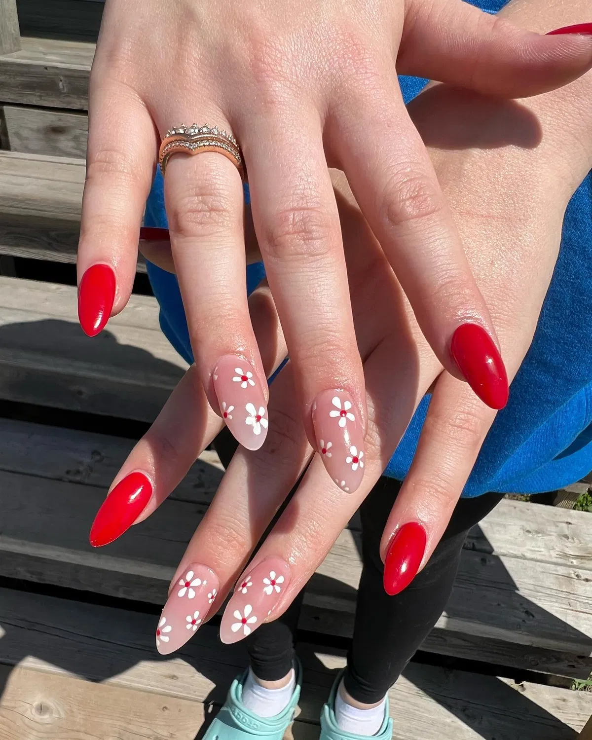 Bright red nails with daisy-style nude accents