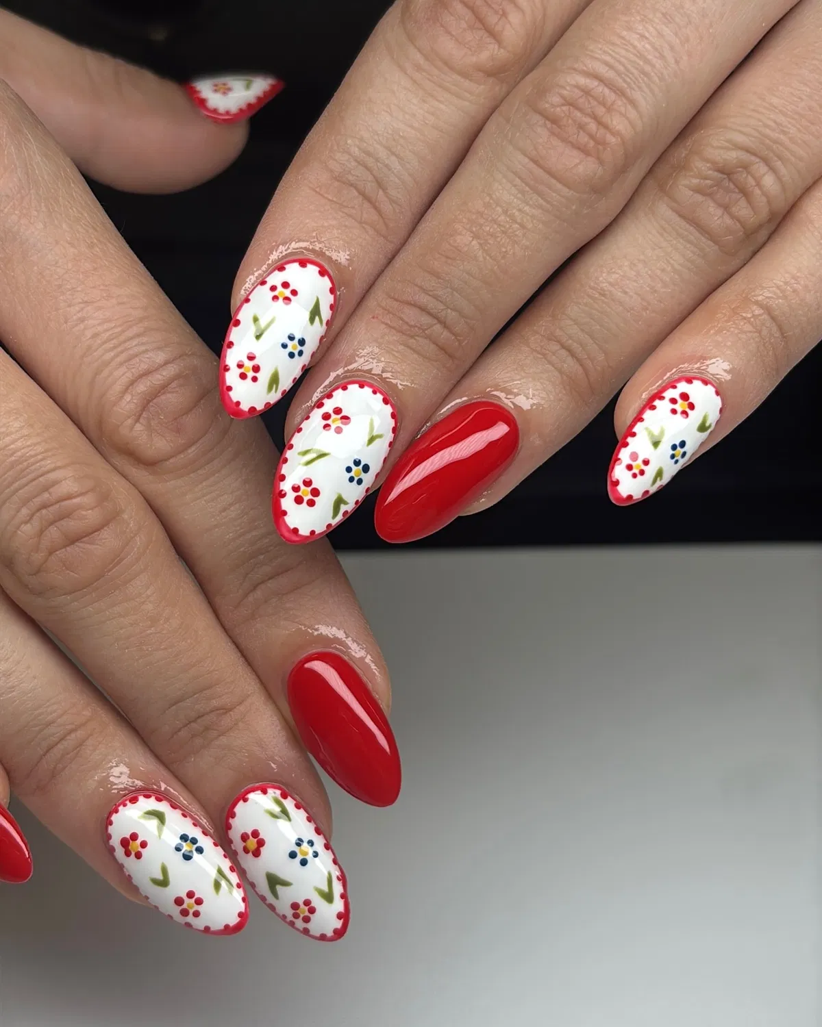 Red solids with white floral-dot nails and red dotted borders