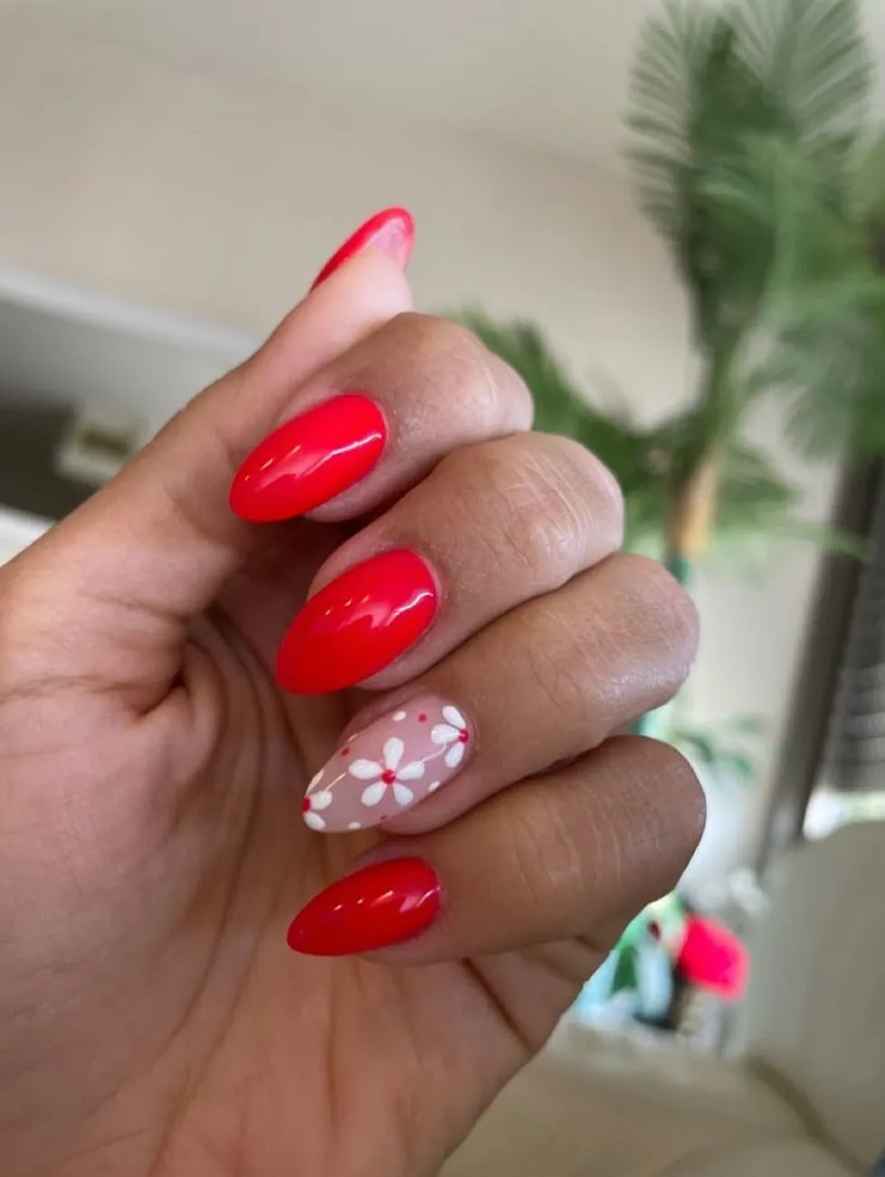Classic glossy red with a white floral accent nail