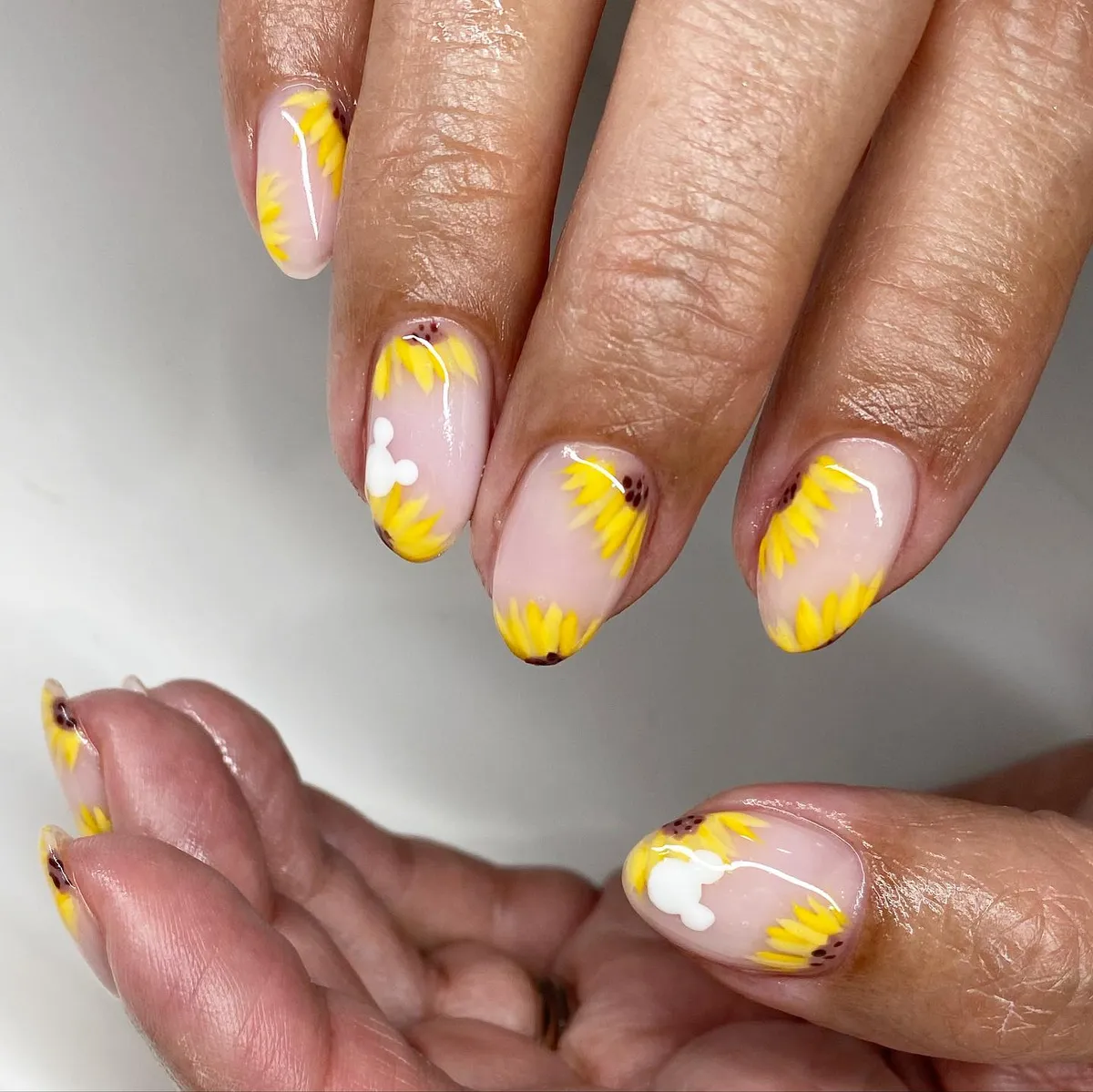 All-over sunflower petal clusters on nude base
