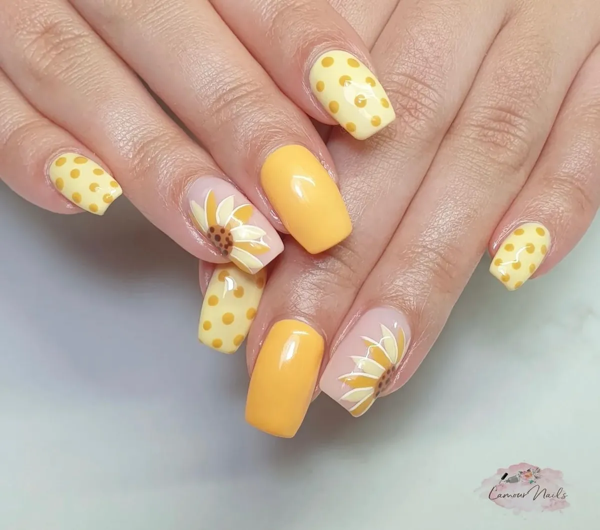 Long square nails with yellow dots and large sunflower accents