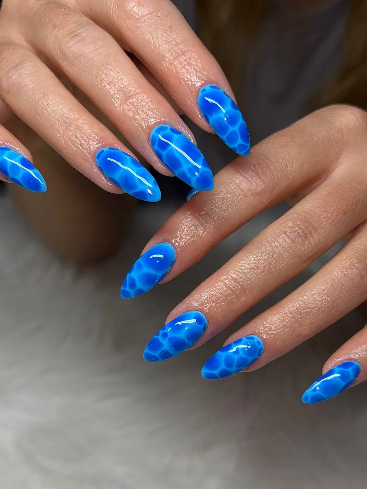 Bright blue cell-pattern nails
