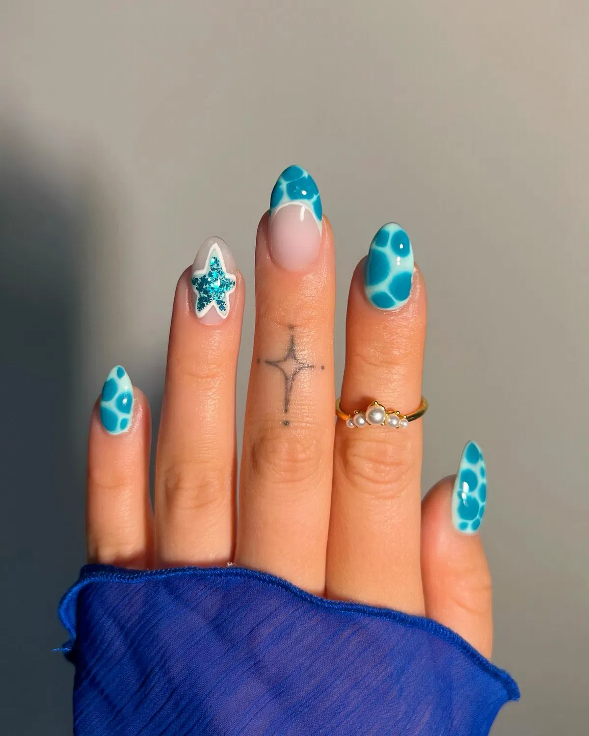 Turquoise patterned tips with glitter star accent