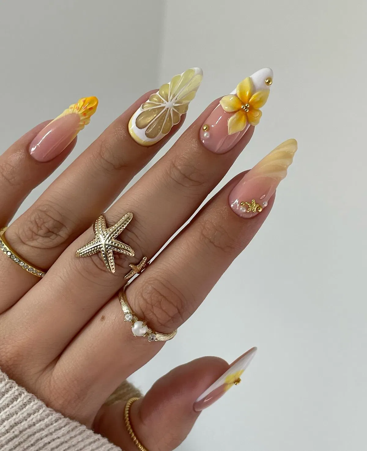 Long almond nails with raised citrus and floral details