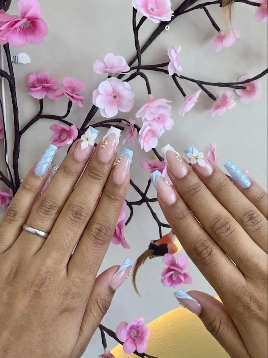 Light blue swirls with white flowers and gold beads