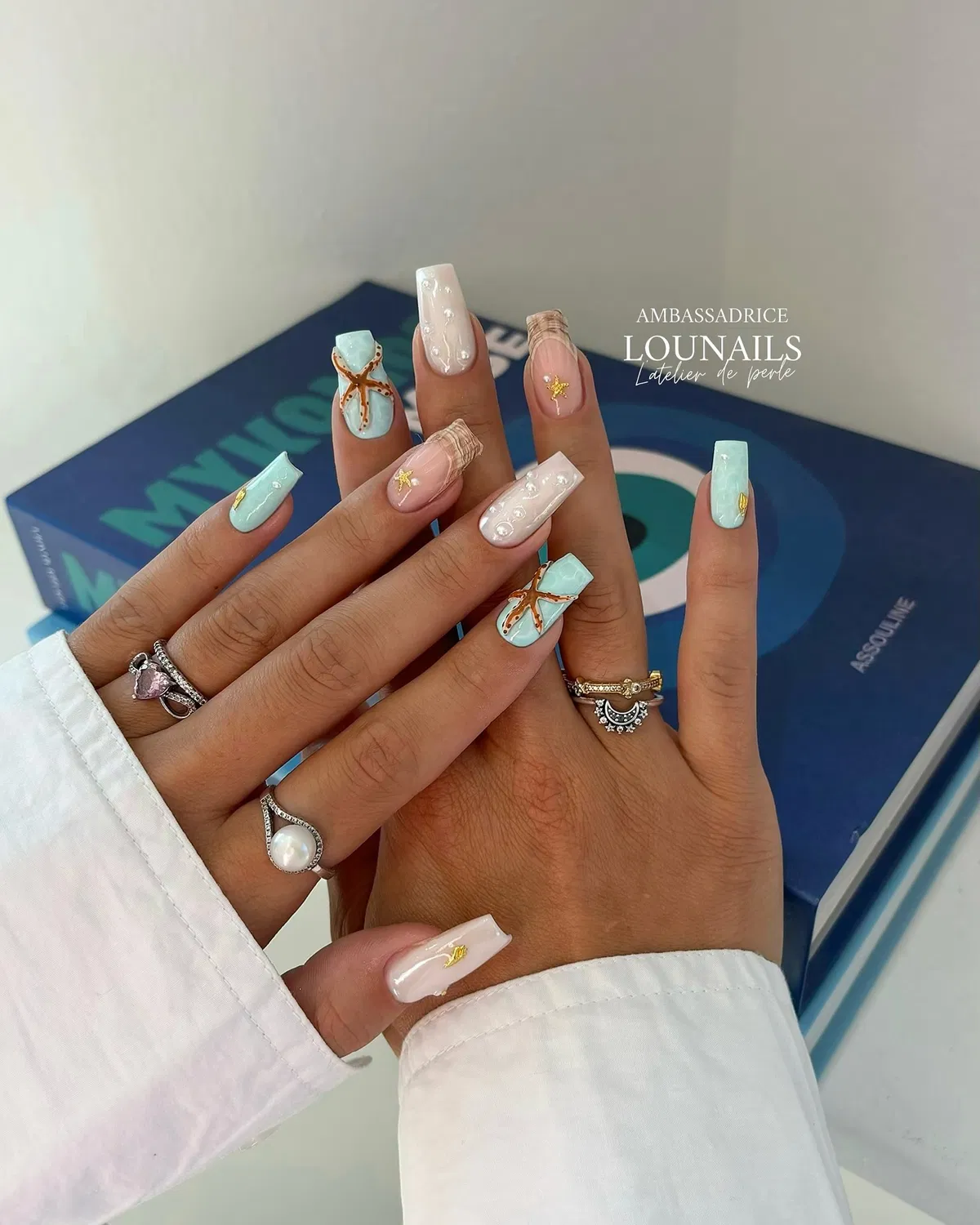 Turquoise starfish and pearl-dotted white accents