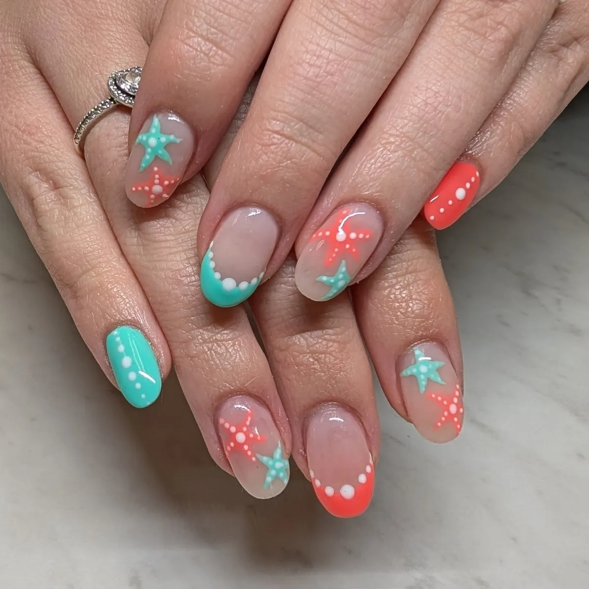 Sheer base with coral-and-teal starfish and dotted tips