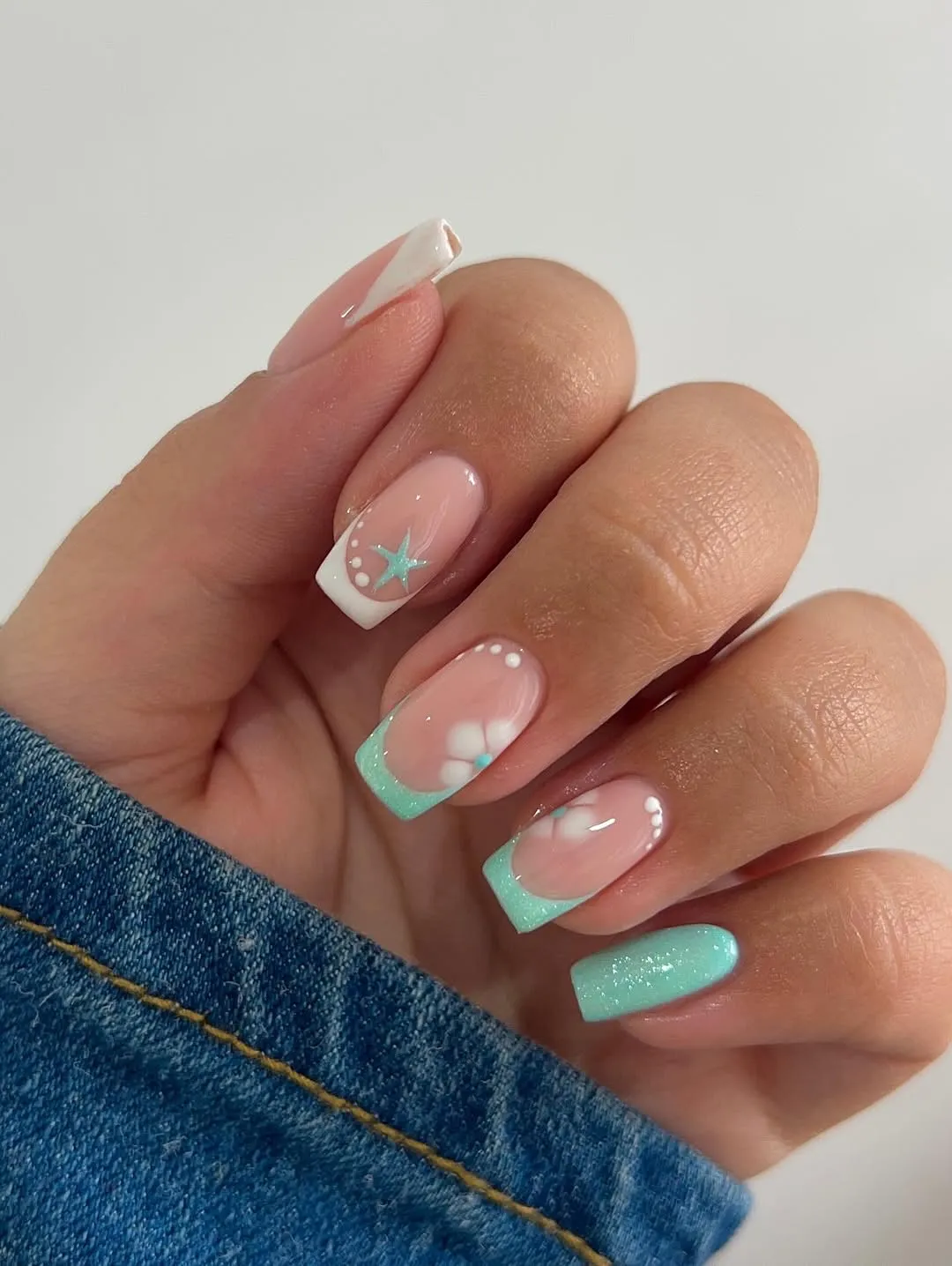 Pink French tips with bright floral accents