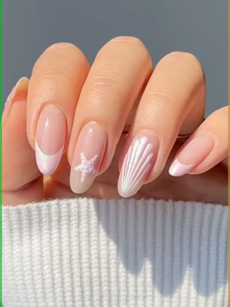 White nails with blue bows, shells, and citrus art